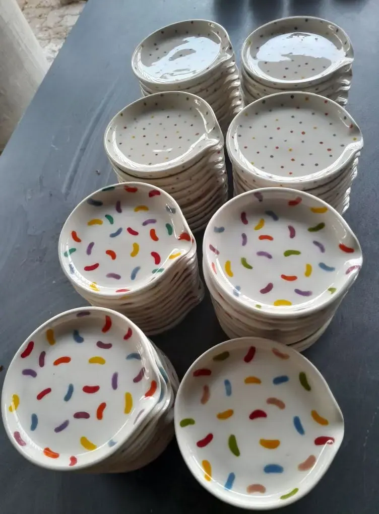 A stack of painted dishes with coloured speckles