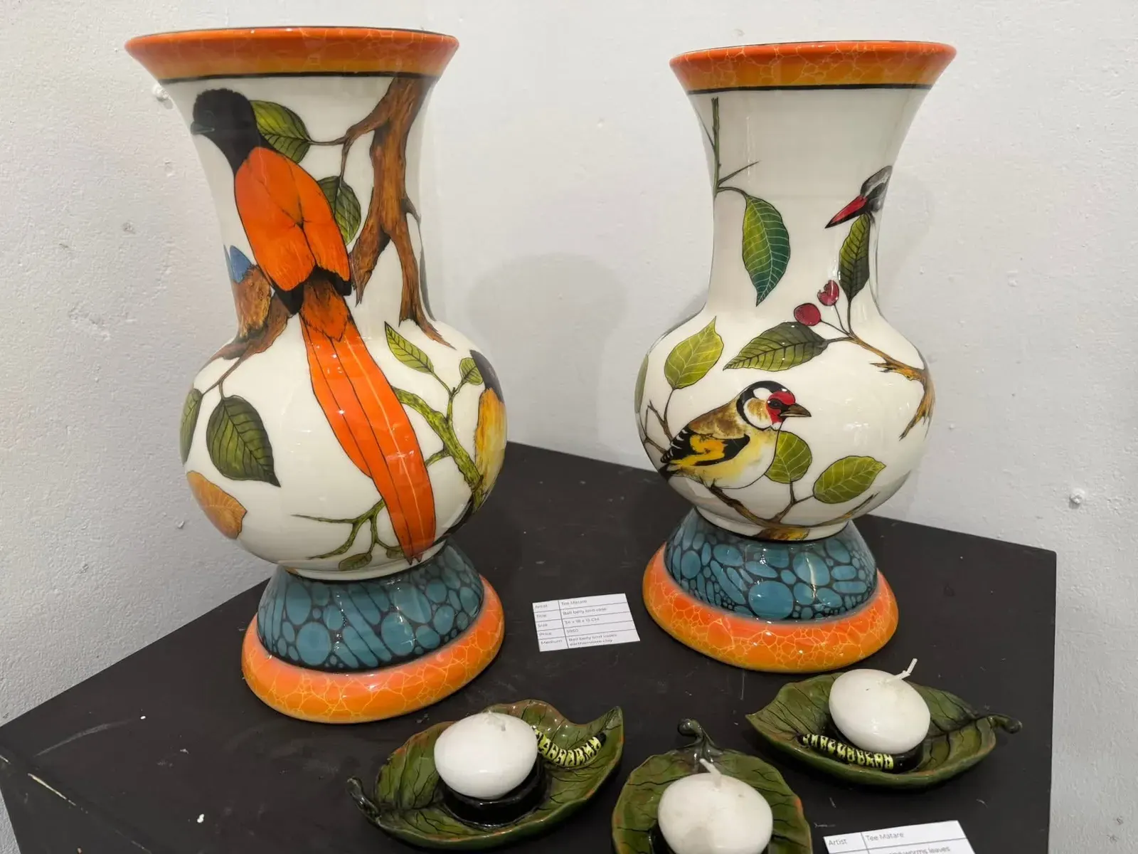 Hand-painted vases with birds and orange detail