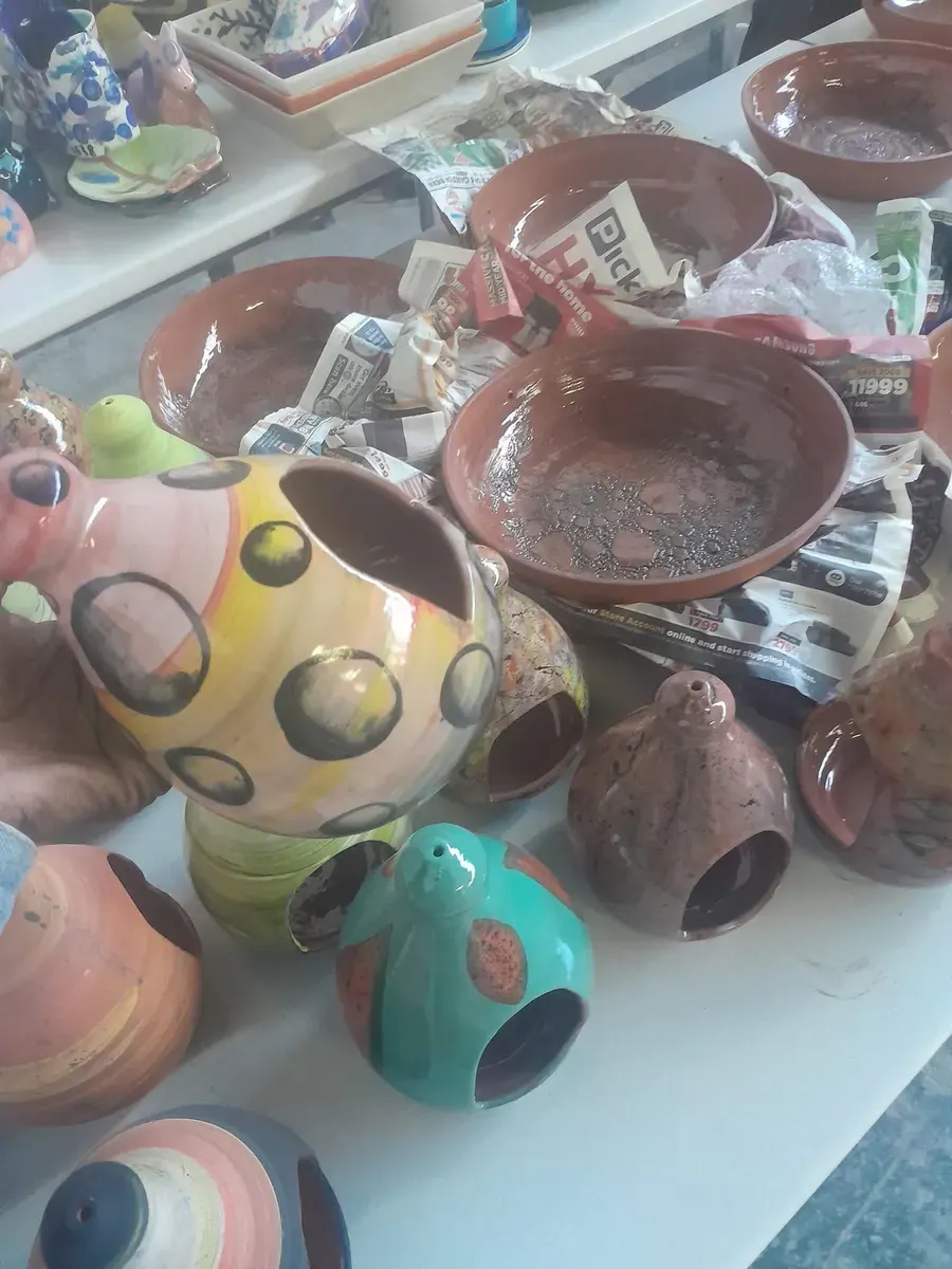 A group of small painted ceramic pots