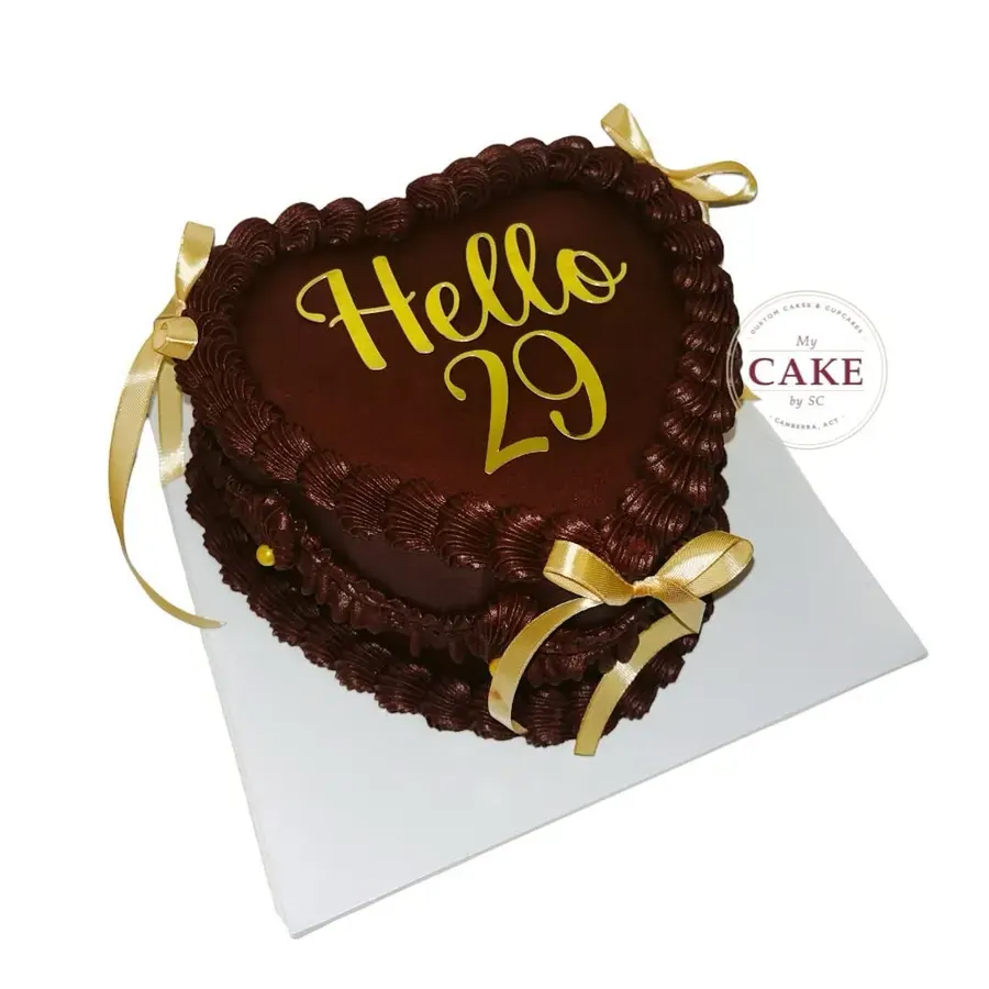A chocolate heart cake saying Hello 29