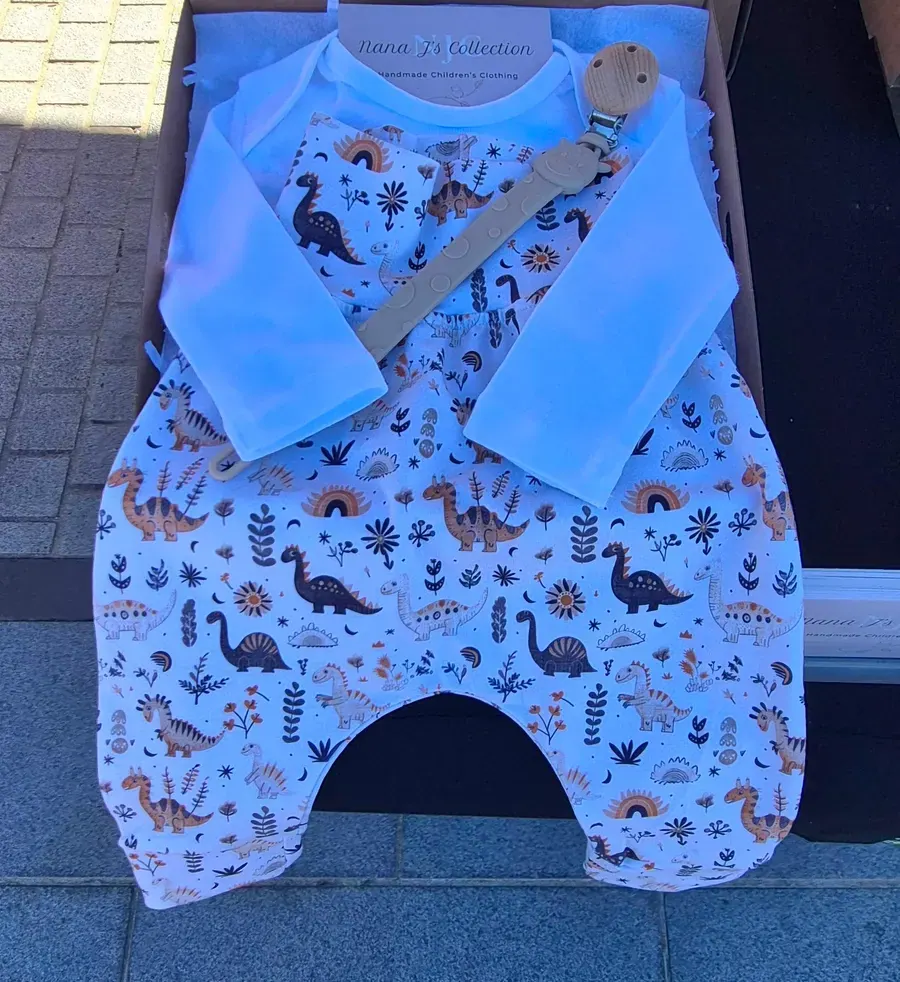 Dinosaur print overalls with a white collar