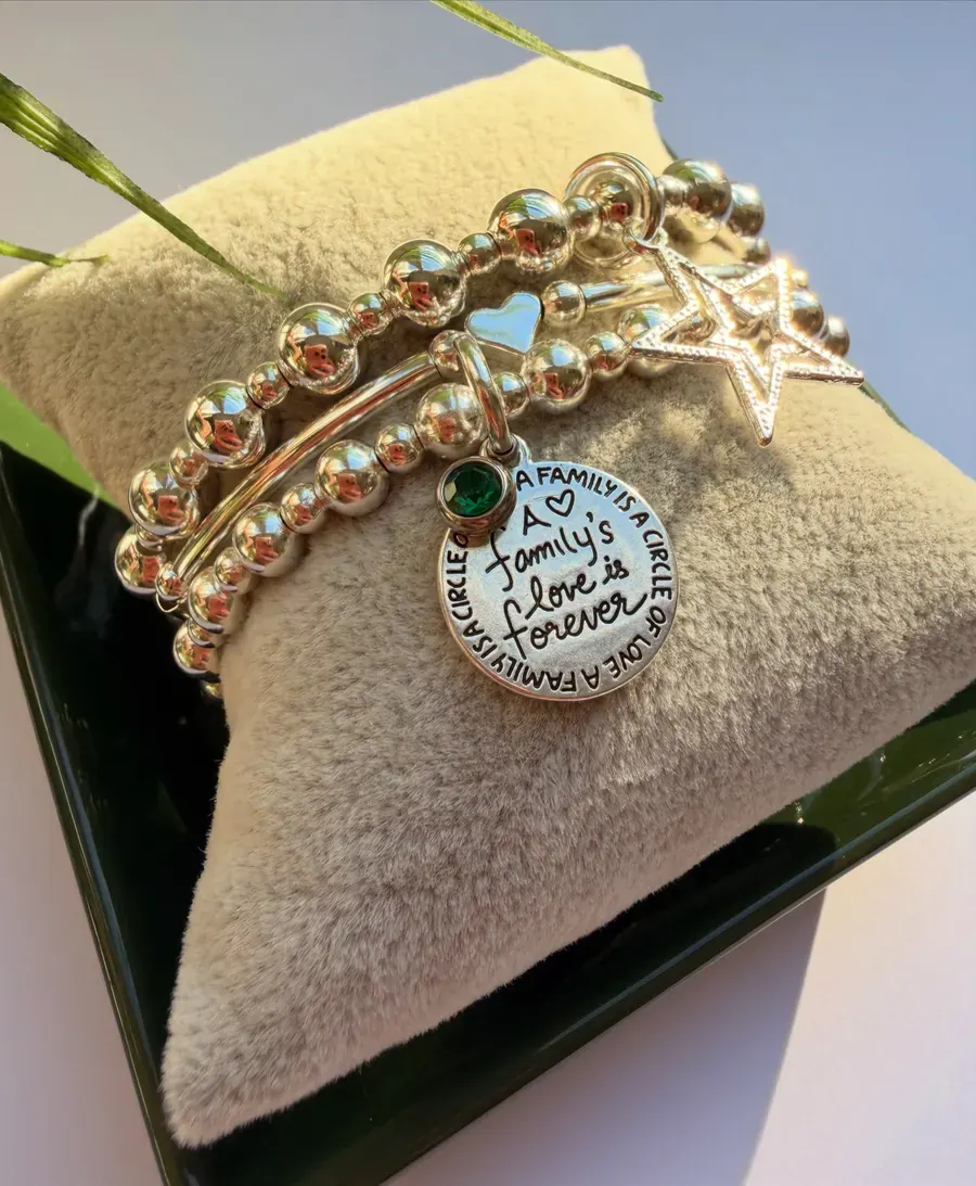 A charm bracelet with a family love pendant