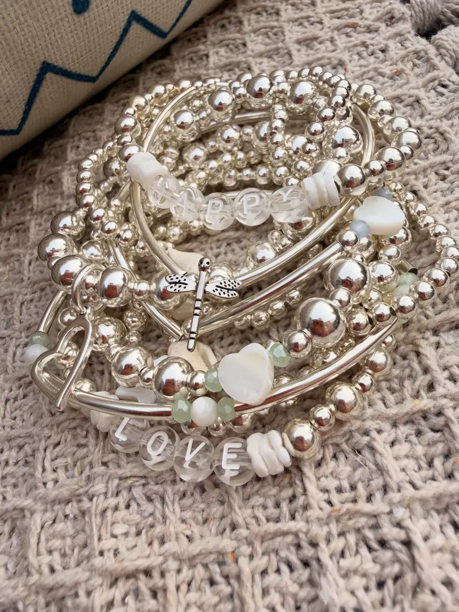 A mix of silver bracelets with LOVE beads