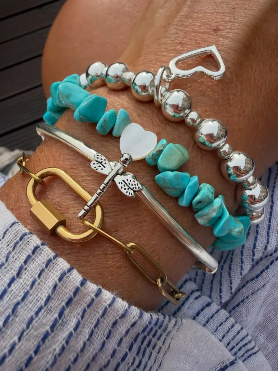 A turquoise and silver layered bracelet stack