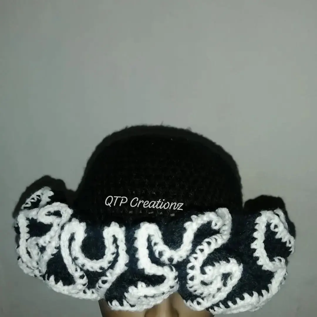 A black and white crochet ruffle bucket hat