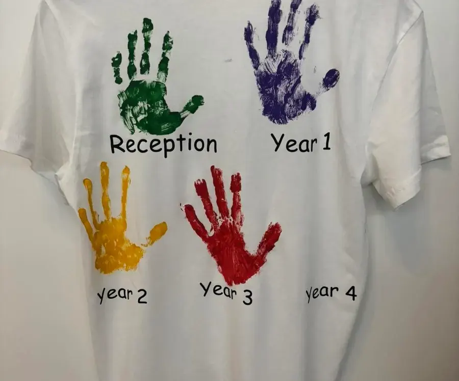 A T-shirt with coloured handprints for each school year