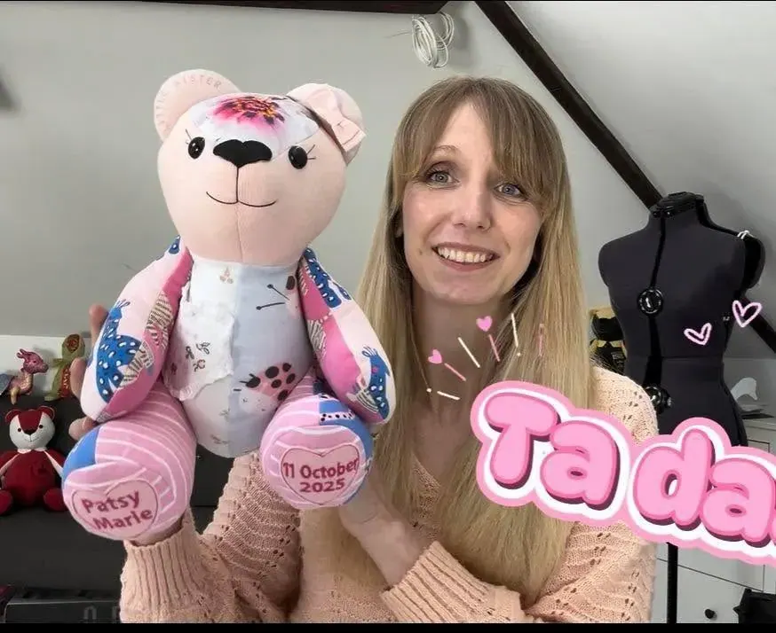The maker holding a finished memory bear