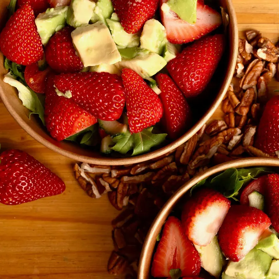 A bowl of strawberries and pecans