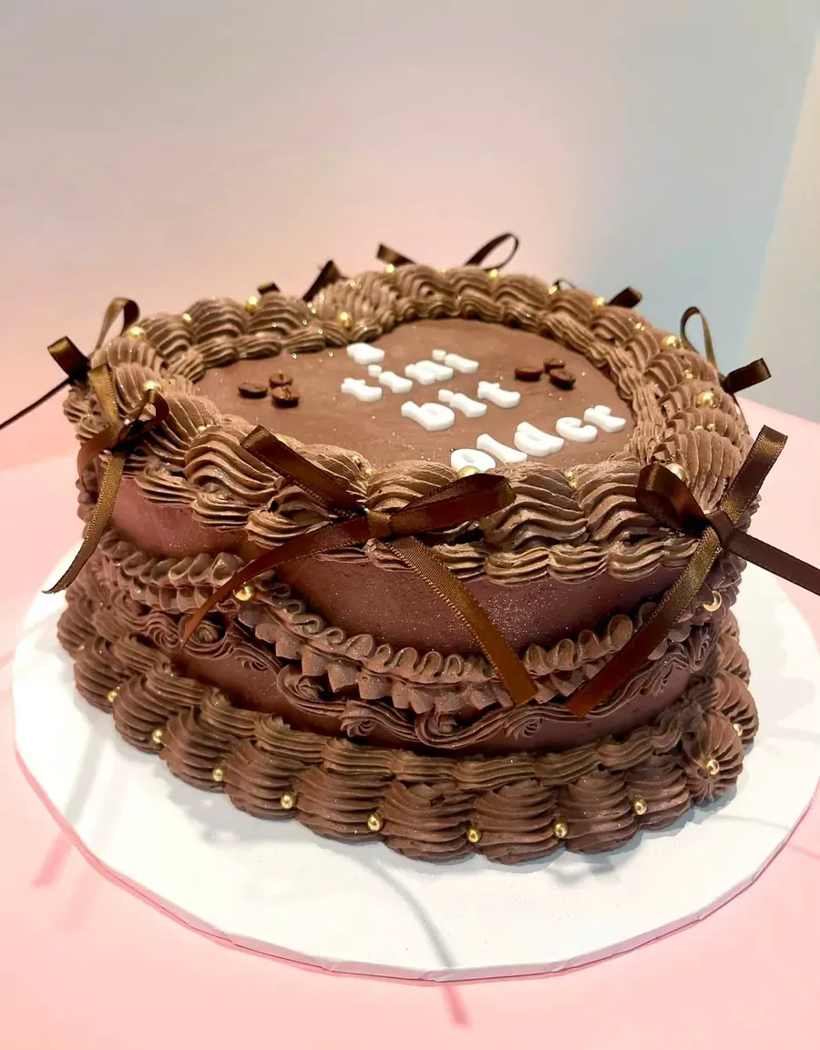 A chocolate buttercream cake with ribbon detail