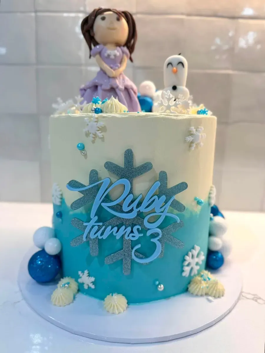 A blue winter themed birthday cake