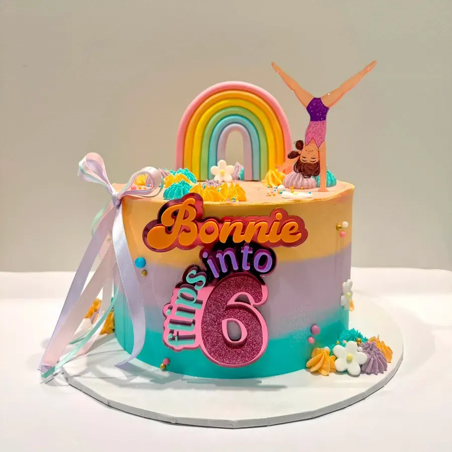 A rainbow birthday cake saying Bonnie turns 6