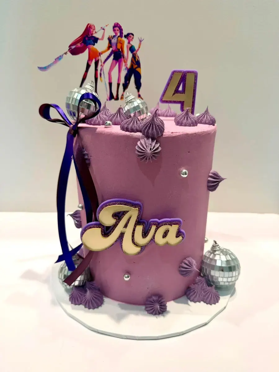 A purple cake with the name Ava