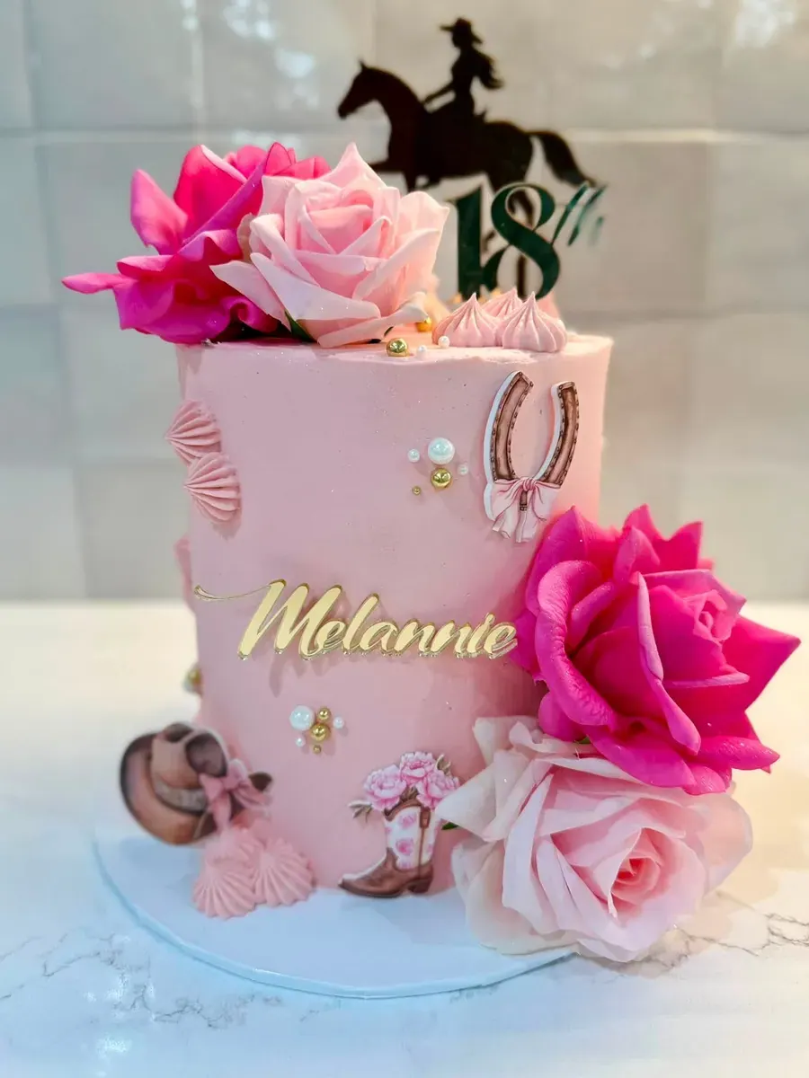 A pink cake with fresh flowers