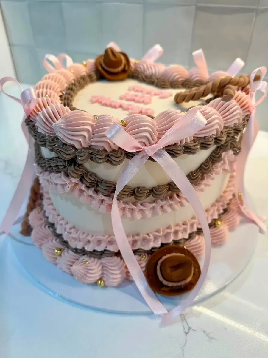 A pink vintage-style cake with bows