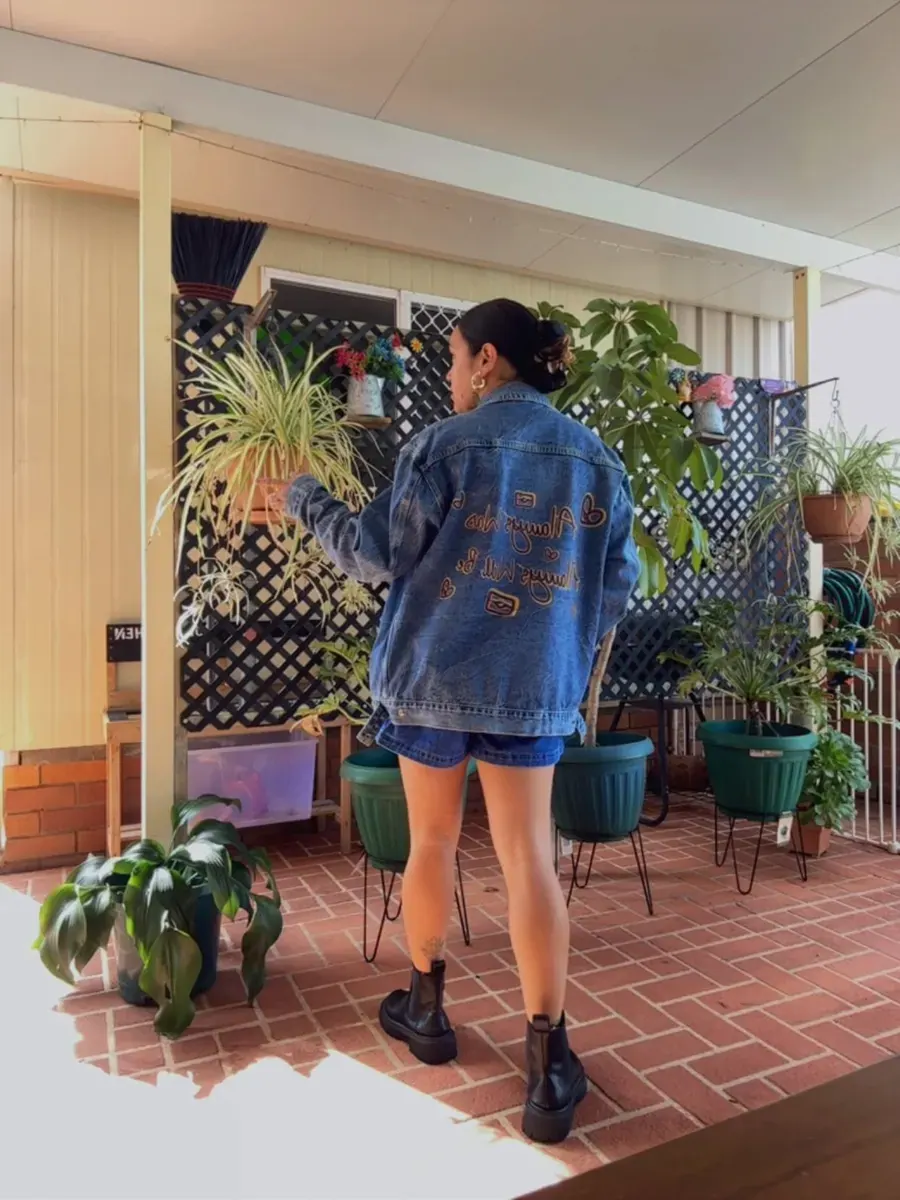 A denim jacket worn with printed shorts