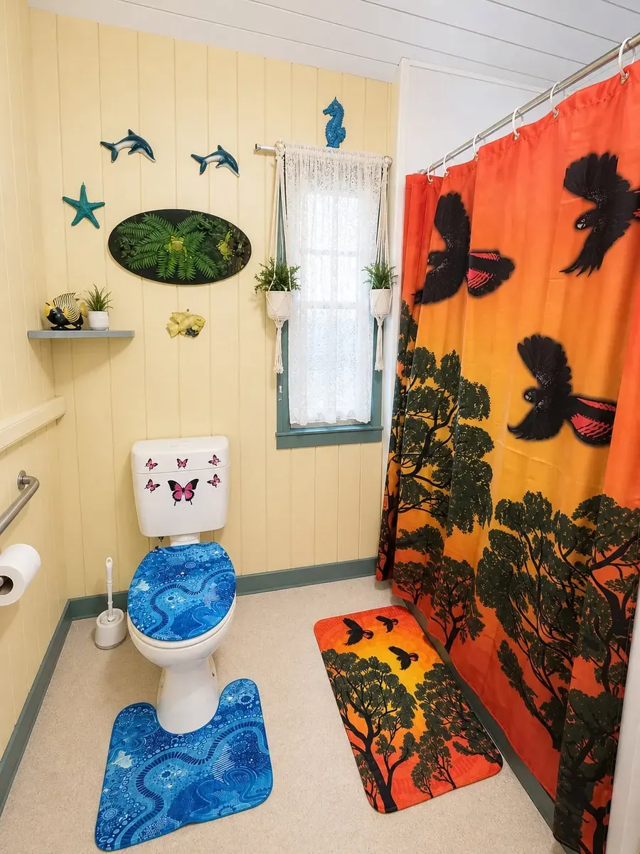 A bathroom with colourful printed towels and a shower curtain